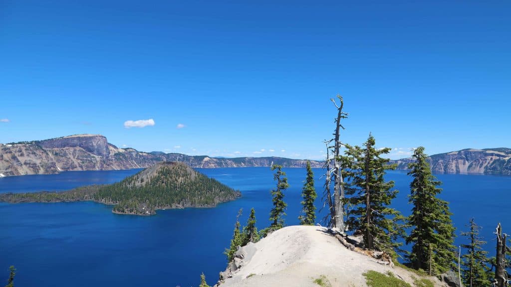 Crater Lake National Park in Oregon is the perfect family vacation. Things to do in the summer include camping, hiking, watching sunrise or sunset, swimming, play in the snow, take a boat ride to Wizard Island and photography. If you plan far enough in advance you can also stay in a park lodge! 