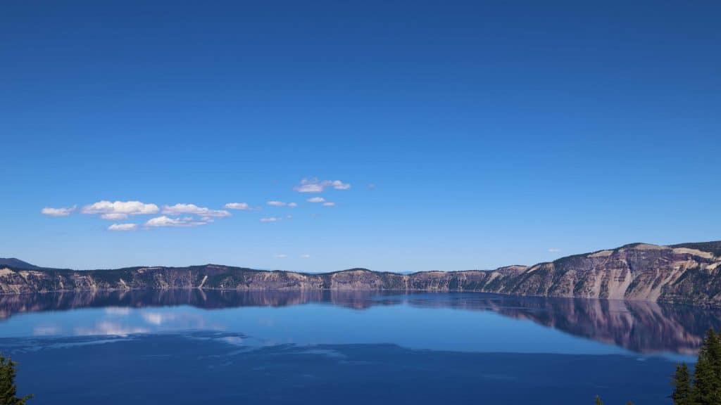 Crater Lake National Park in Oregon is the perfect family vacation. Things to do in the summer include camping, hiking, watching sunrise or sunset, swimming, play in the snow, take a boat ride to Wizard Island and photography. If you plan far enough in advance you can also stay in a park lodge! 