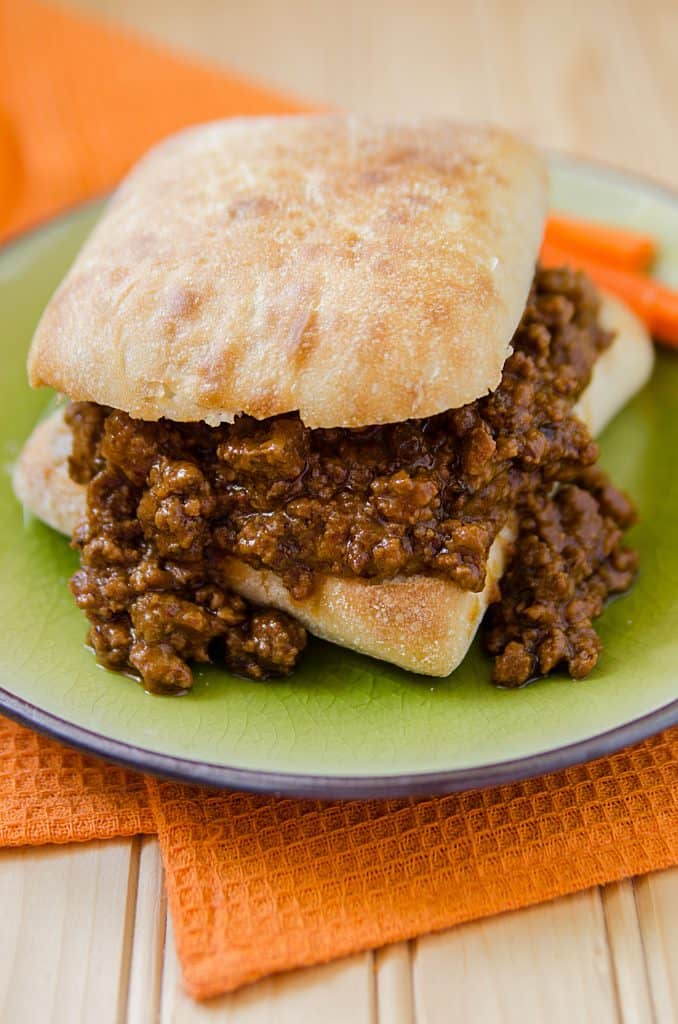 Easy homemade slow cooker crock pot spicy sloppy joes great for a crowd. This is hands down the best slow cooker Crock Pot Sloppy Joes Recipe ever! It is an easy to make homemade recipe that will have everyone who loves a little spice in their life coming back for more! 