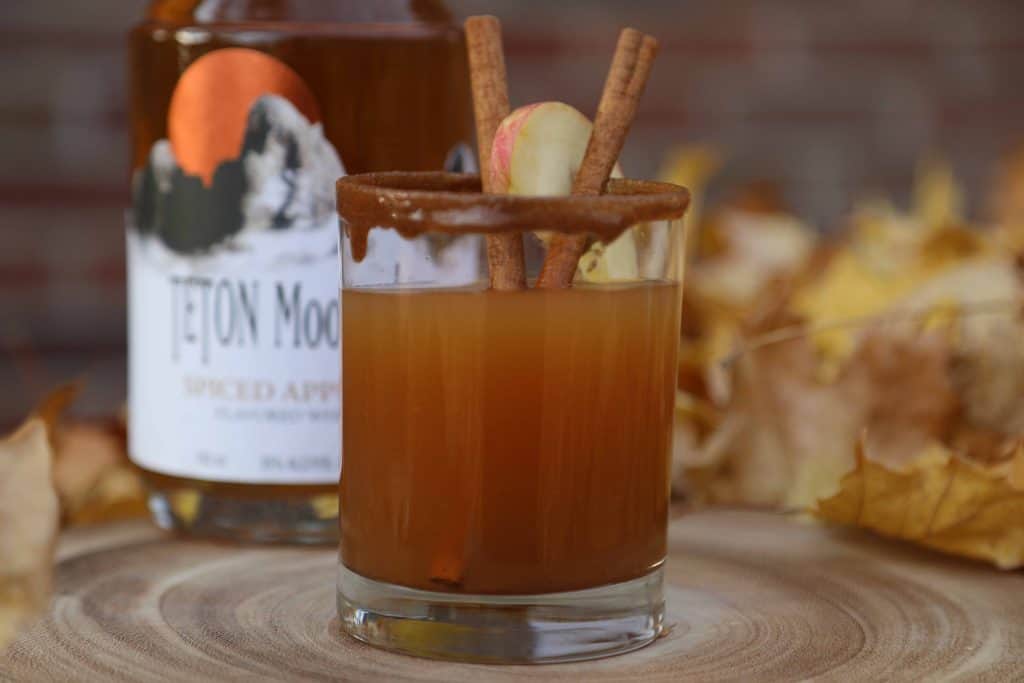 This Spiced Apple Pie Cocktail has all the classic fall drinks flavors everyone loves including apple, caramel, and cinnamon. It's like fall in a glass! 