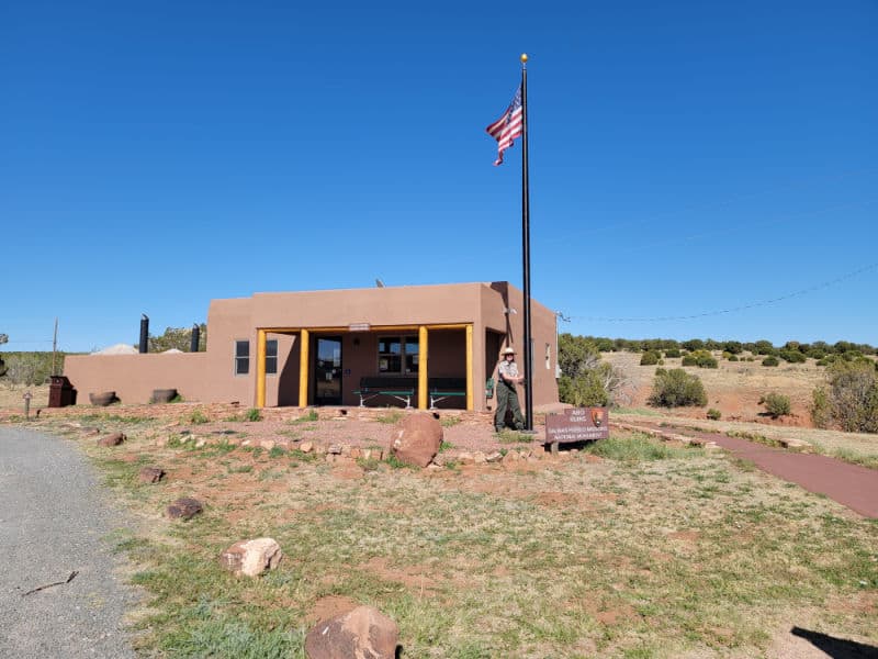 park ranger lowering the flag at the Abo Ruins visitor center in Salinas Pueblo Missions National Monument, New Mexico