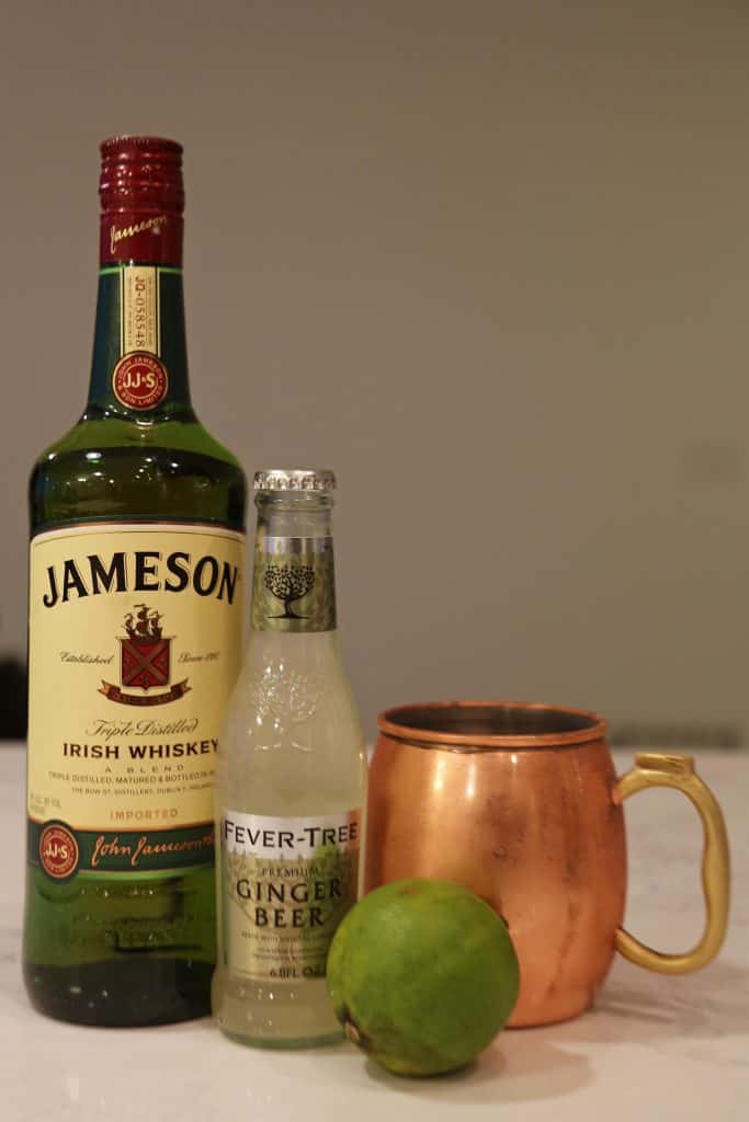 Bottle of Jameson Irish Whiskey, ginger Beer, copper mug and lime