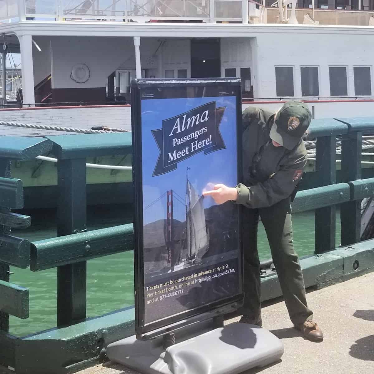 Ranger at sign to line up for the 1891 Scow Schooner Alma sailing into San Francisco Bay