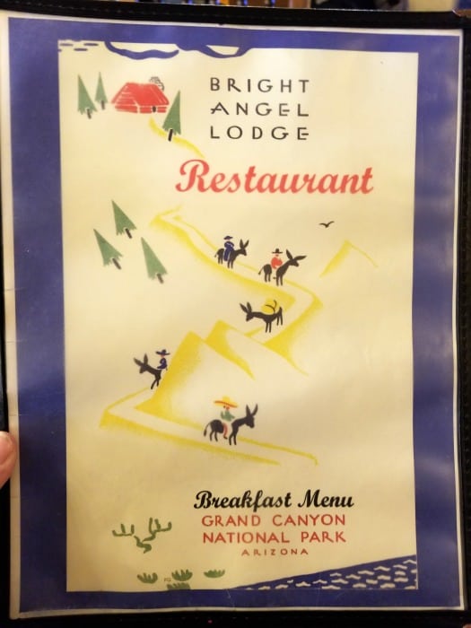 Front cover of the restaurant menu with a cartoon of donkeys going into the Grand Canyon