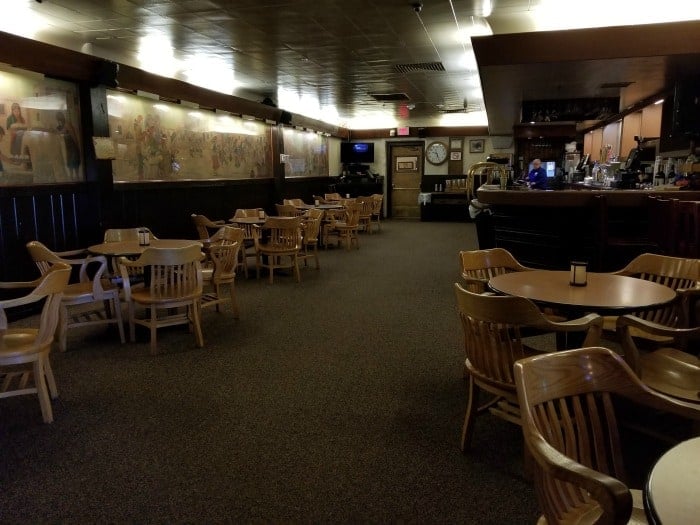 dark restaurant bar with tables and chairs