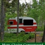 Photo of a campsite with an RV with text "Many GlacierCampground Glacier National Park by ParkRangerJohn.com"