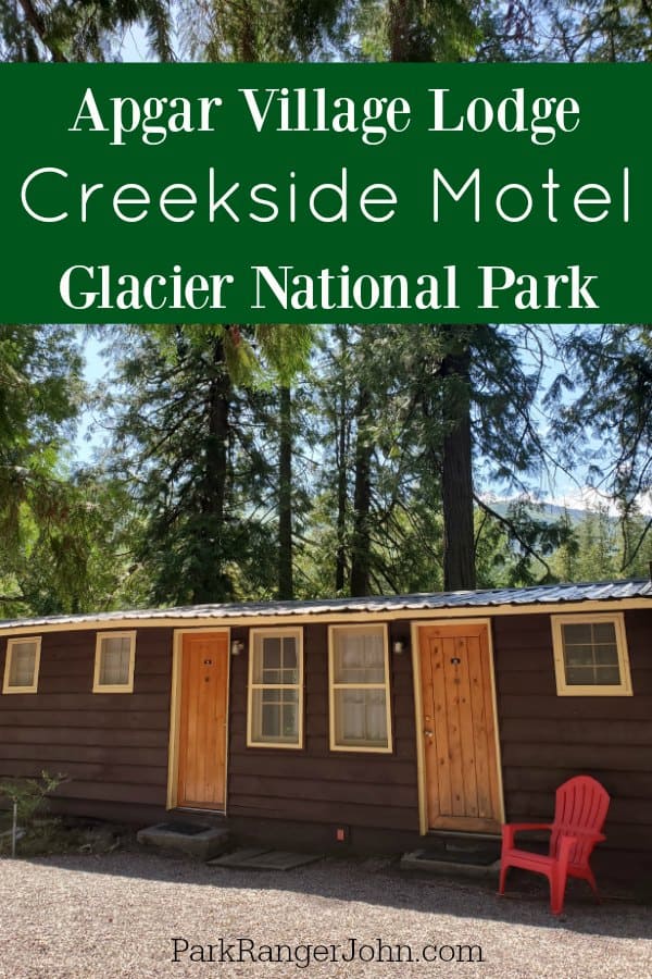 Wooden doors and red Adirondack chair at Apgar Village Lodge, Creekside motel