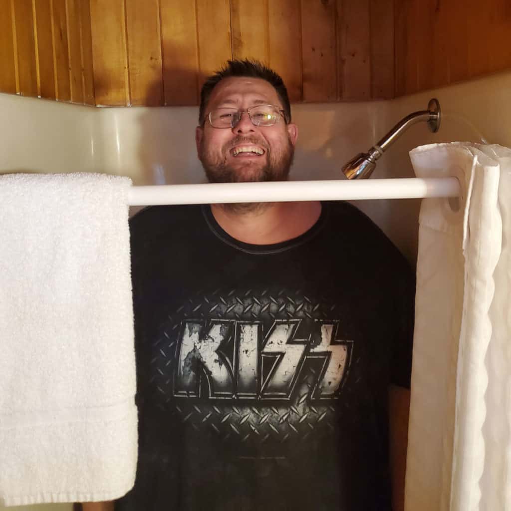 John standing in the shower at Apgar Village Lodge in Glacier