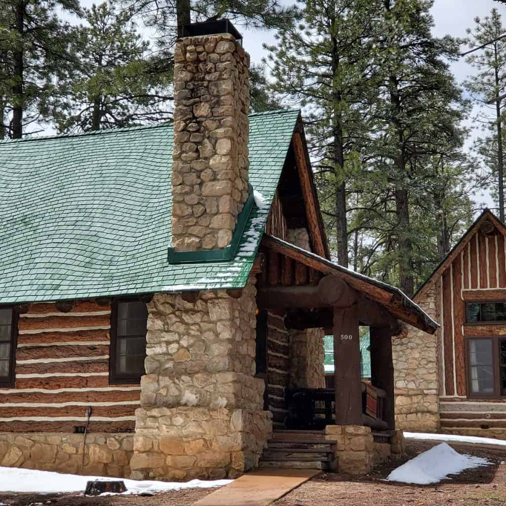 Log Cabin with stone fireplace and green roof on the Western Cabins Bryce Canyon Lodge