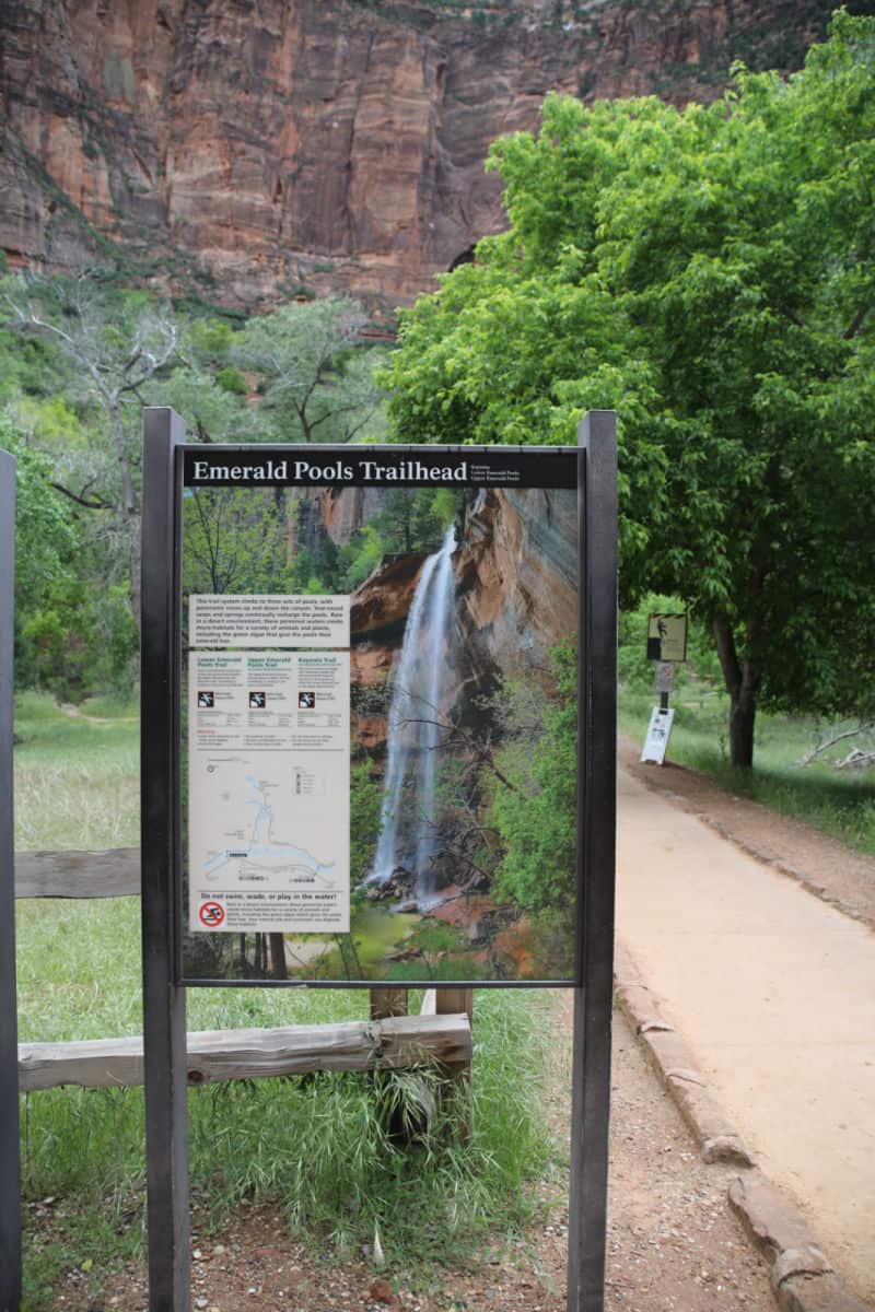 Beginning of the Emerald Pools Trail at Zion National Park with park sign describing trail