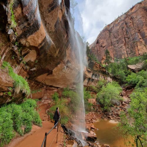 Hiking under the Lower Emerald Pools waterfall at Zion National Park