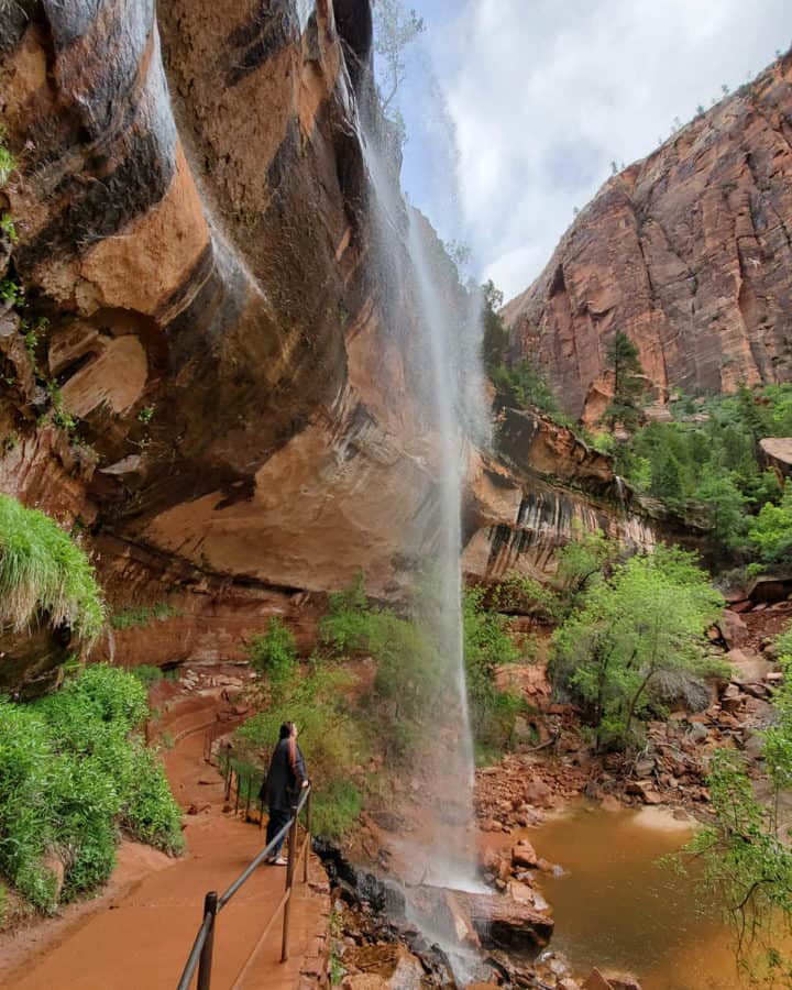 Hiking under the Lower Emerald Pools waterfall at Zion National Park