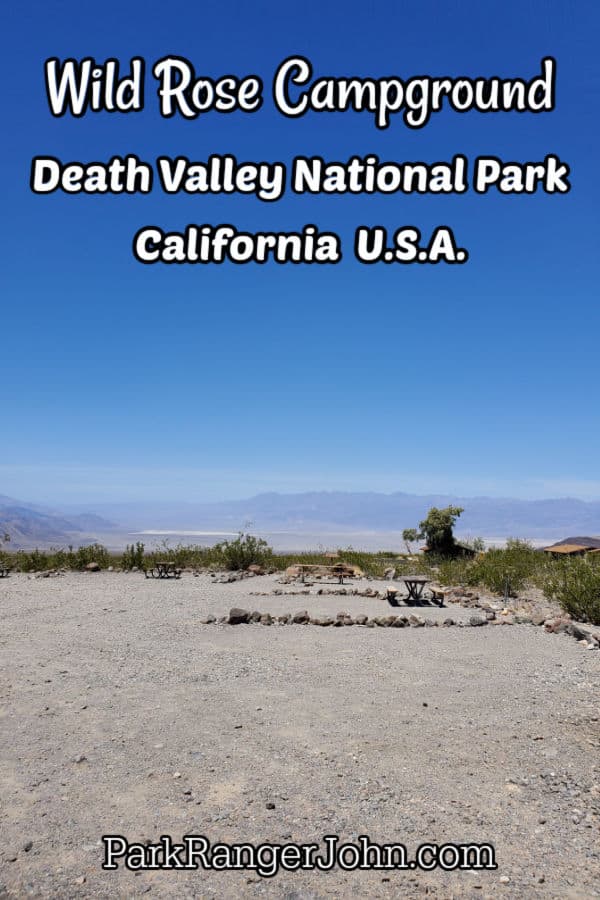 Wild Rose Campground Death Valley National Park text over dirt campground with mountains in the background