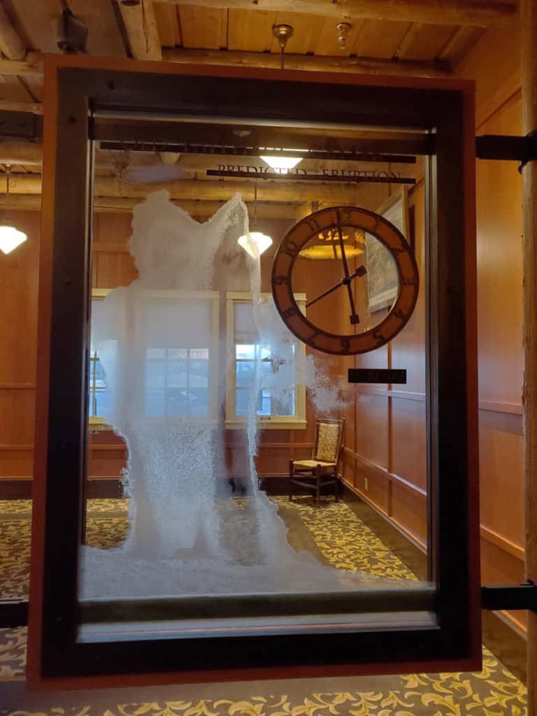 Clock showing Old Faithful estimated eruption time in Old Faithful Frontier Cabin next to Old Faitful Frontier Cabins