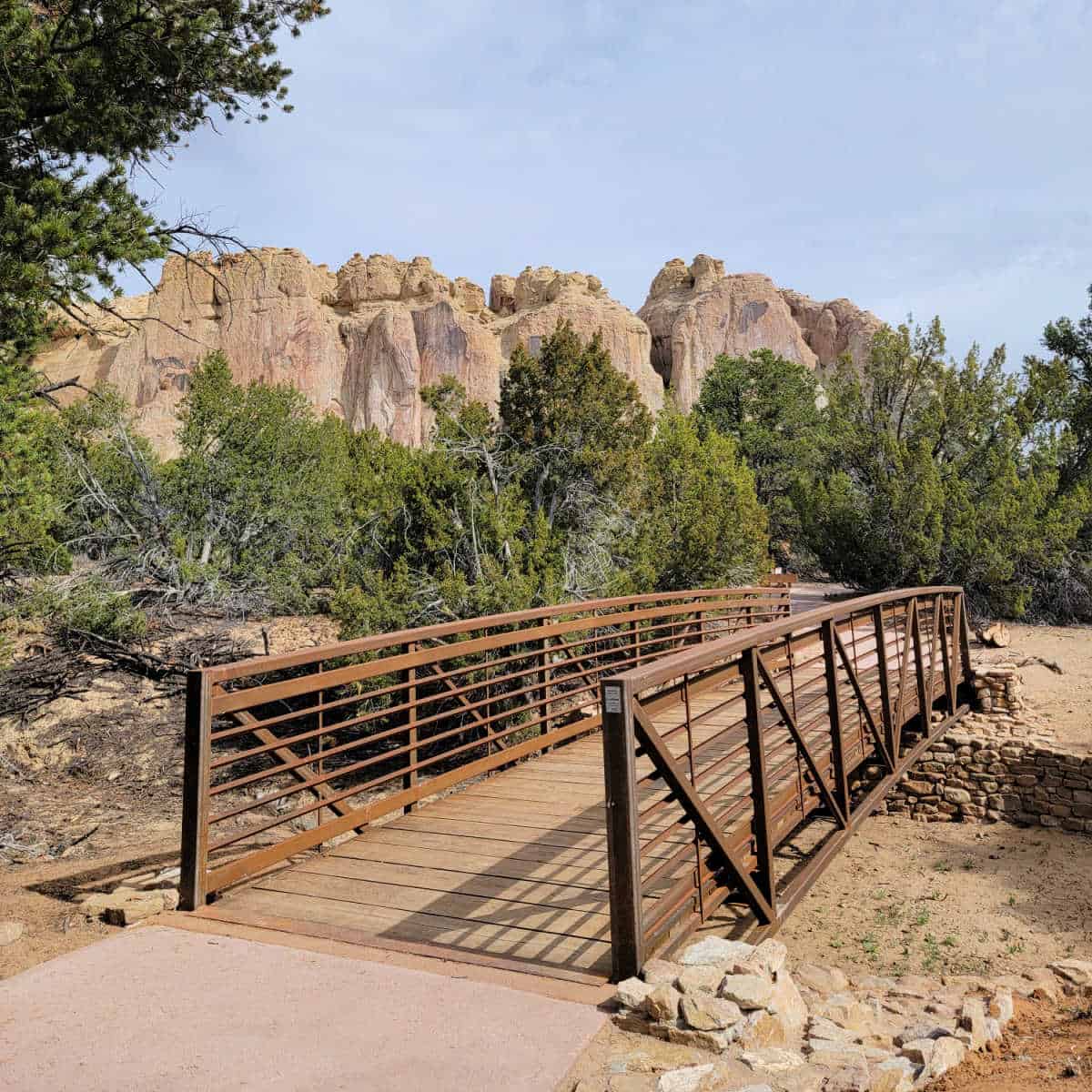 crossing a bridge while hiking the Inscription Rock Trail Loop at El Morro National Monument in New Mexico