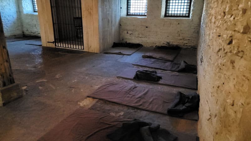 Jail cell with mats on the floor in Fort Smith NHS