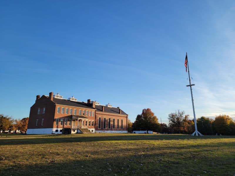 Historic Fort Smith National Historic Site visitor center and jail with an American flag on the parade grounds