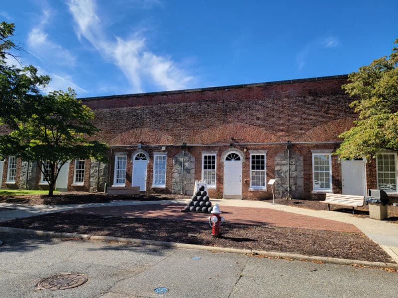 historic casemate museum with a stack of cannon balls by the door in Fort Monroe National Monument