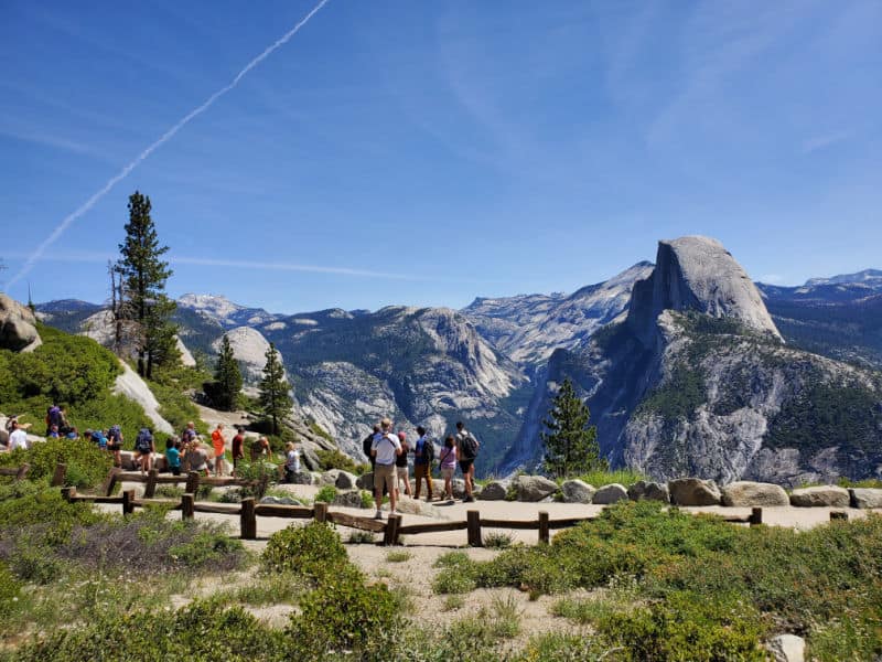Visitors looking out at Half Dome from Glacier Point in Yosemite National Park