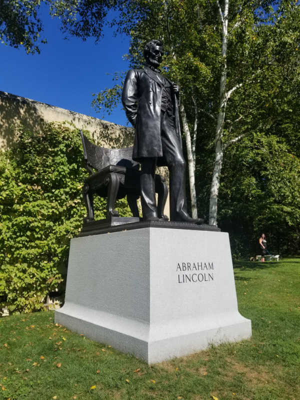 Abraham Lincoln sculpture on a white marble base at Saint Gaudens National Historical Park, New Hampshire