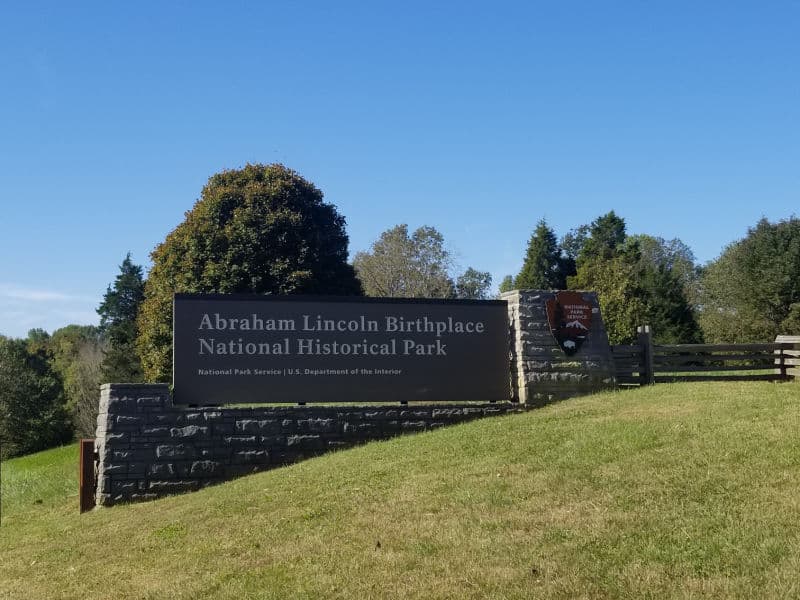 Entrance sign on a grassy hill leading into Abraham Lincoln Birthplace National Historical Park, Kentucky