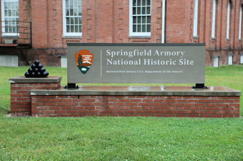 Springfield Armory National Historic Site entrance sign with cannon balls next to it