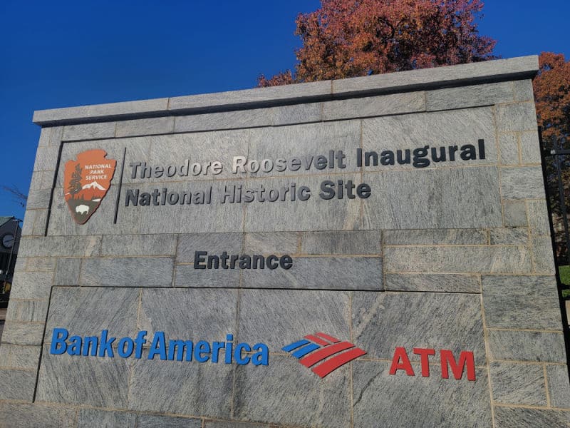 Theodore Roosevelt Inaugural Site National Historic Site entrance sign with trees behind it