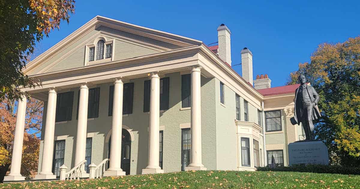 Historic Wilcox Mansion with a statue of Theodore Roosevelt in front of it at Theodore Roosevelt Inaugural National Historic Site in Buffalo, New York