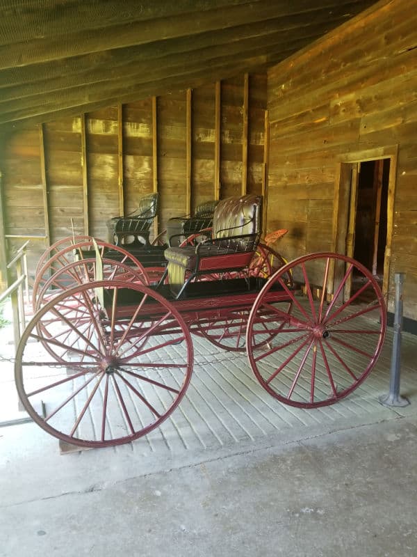Two historic carriages in a wooden barn at Saint Gaudens National Historical Park, New Hampshire