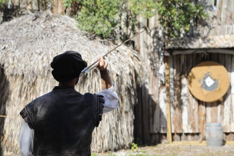 Historic weapons demonstration with a ranger holding an arrow near a target in De Soto National Memorial