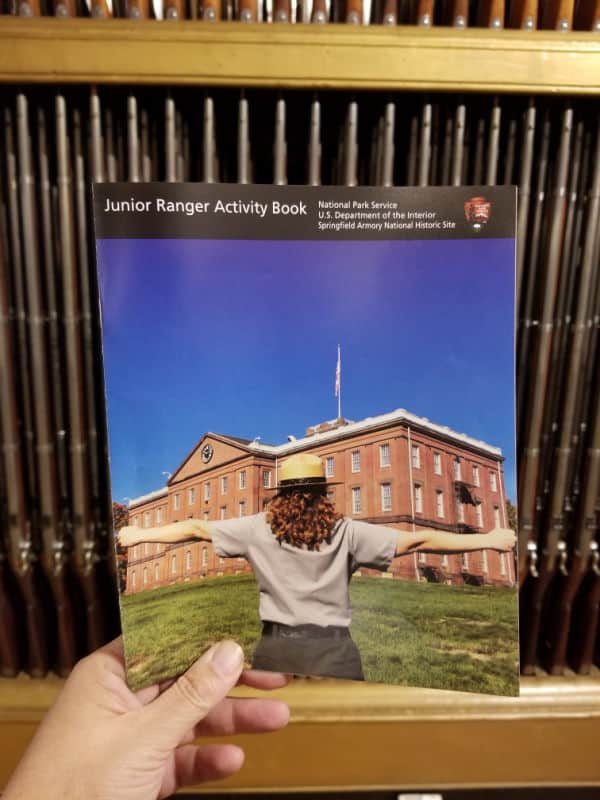 Springfield Armory NHS Junior Ranger Program in front of the organ of muskets