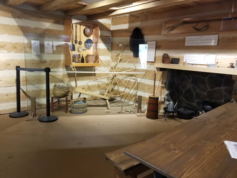Lincoln Cabin exhibit with spinning wheel and fireplace in the visitor center of Abraham Lincoln Birthplace National Historical Park, Kentucky