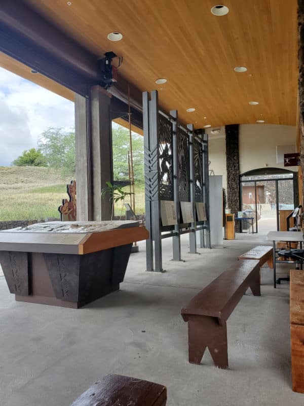 Outdoor interpretive displays and wooden benches at Pu`ukoholā Heiau National Historic Site, Big Island of Hawaii