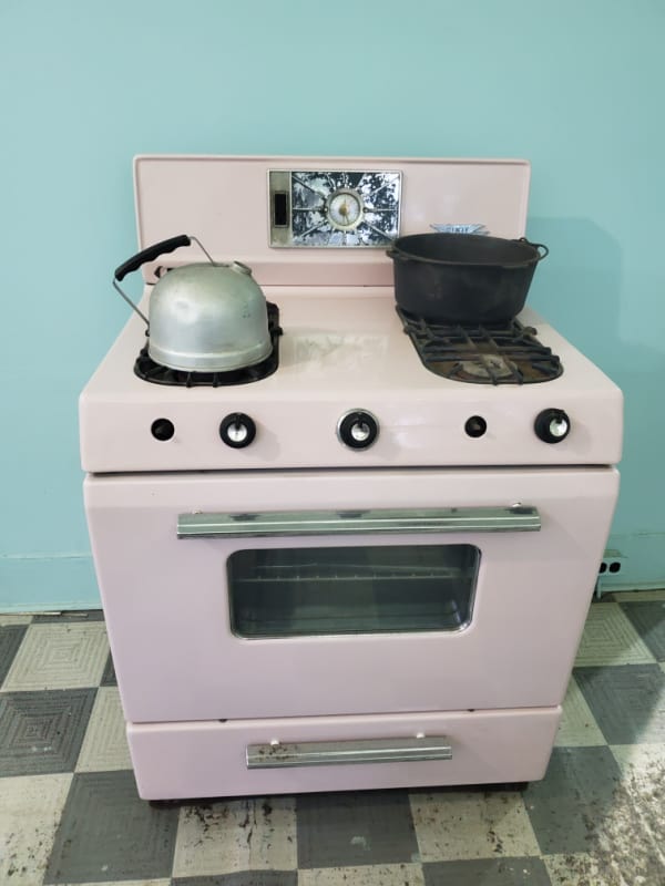 Retro pink stove with tea kettle in the Magnolia Plantation Kitchen at Cane River Creole NHP