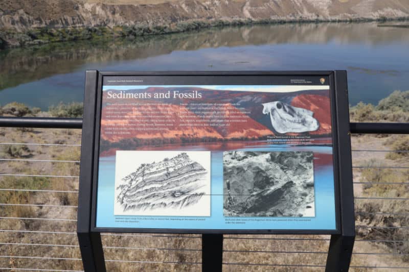 Sediment and fossils interpretive panel with the snake river in the background in hagerman fossil beds national monument in idaho