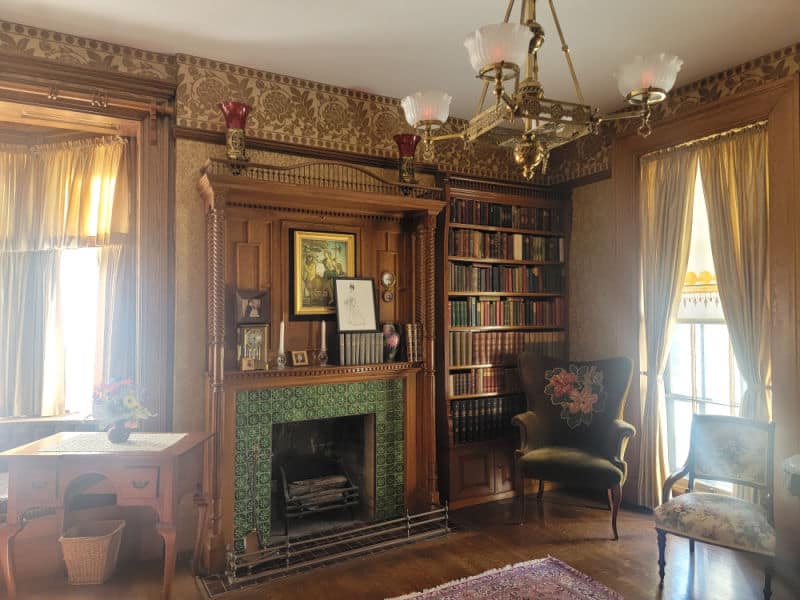 Wilcox House Library with fireplace and chandelier at Theodore Roosevelt Inaugural Site National Historic Site, New York
