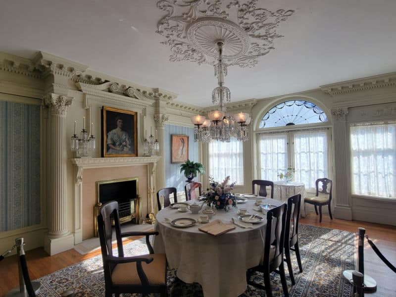 Wilcox house historic dining room with chandelier and fireplace at Theodore Roosevelt Inaugural Site National Historic Site, New York