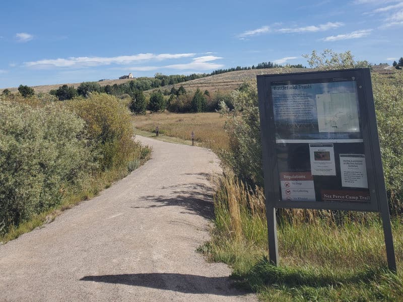 Battlefield trail sign and walking path in Big Hole National Battlefield