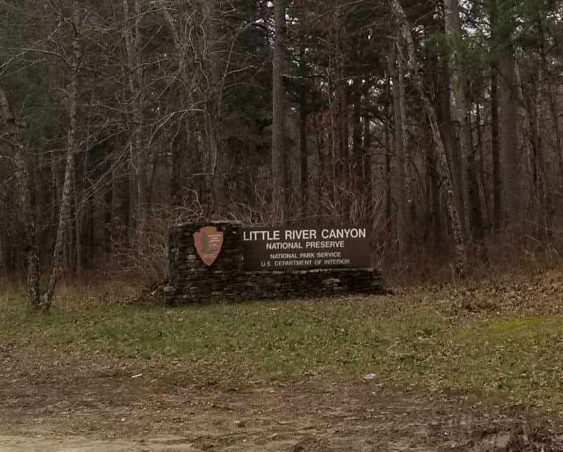 Little River Canyon National Preserve entrance sign with trees behind the sign