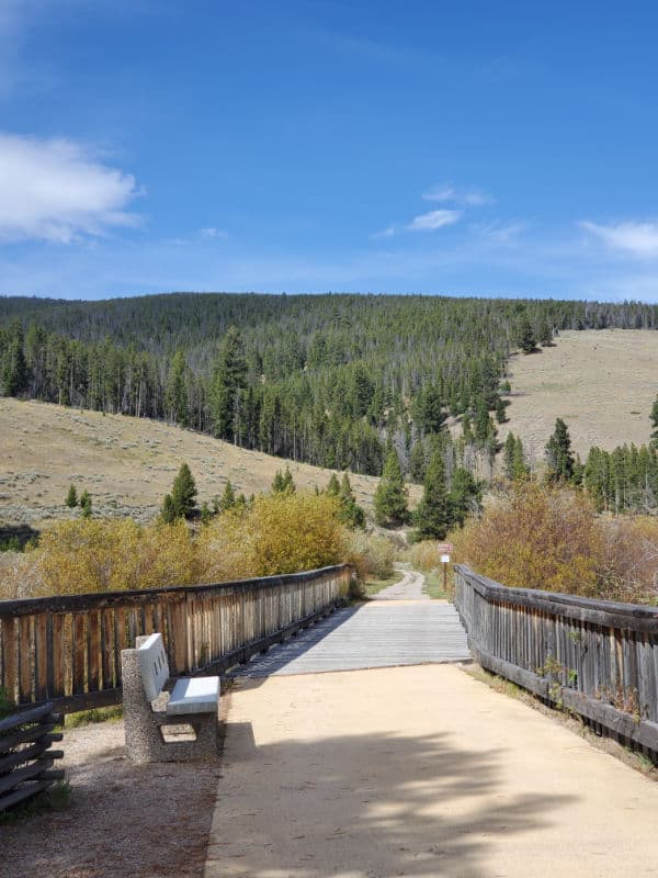 paved trail over a bridge leading towards a mountain in Big Hole National Battlefield