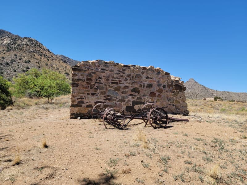 Historic fort wall ruins and a cart in Fort Bowie National Historic Site