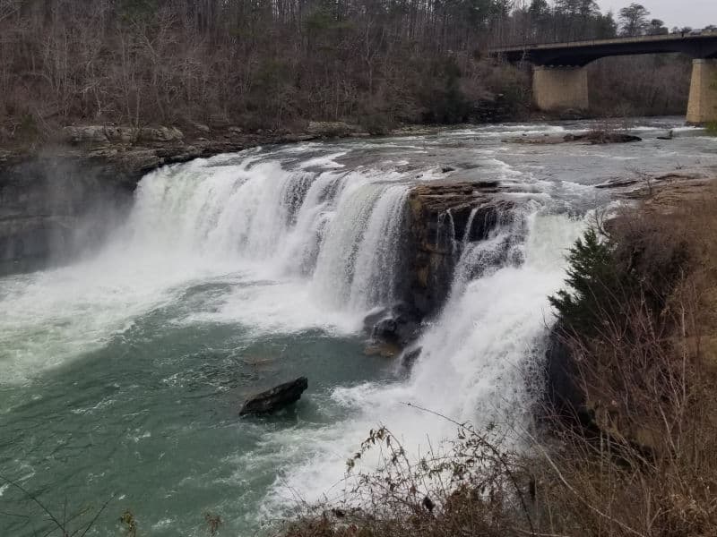 little river falls with a bridge in the background in little river canyon national preserve