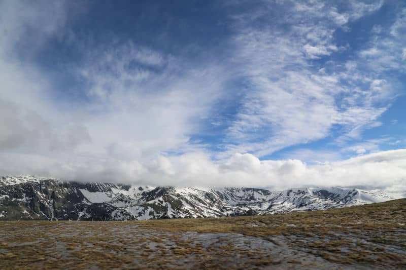 Rocky Mountains with snow on a cloudy but sunny day