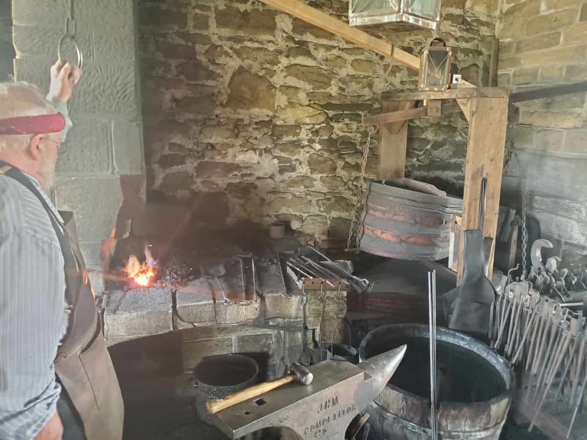 Historic Blacksmith shop with a man working with fire