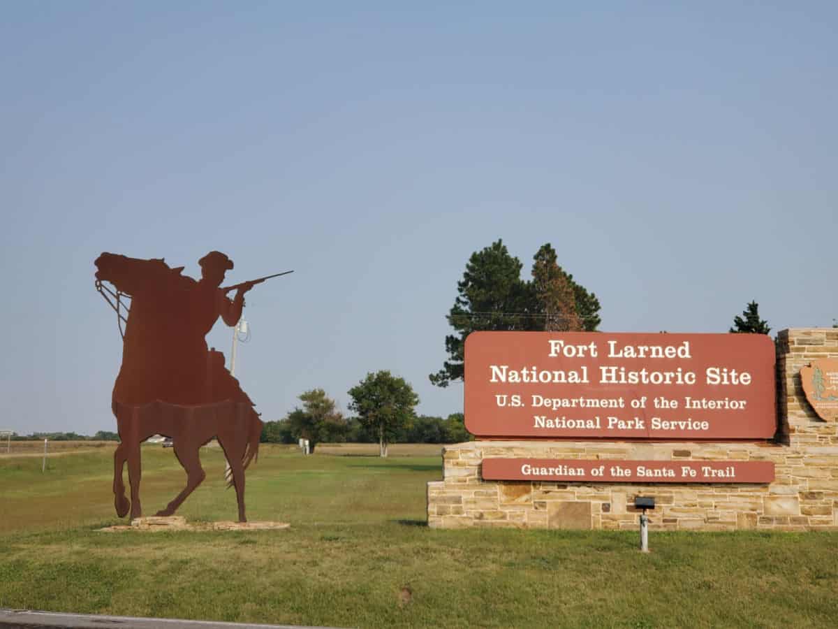 Fort Larned National Historic Site entrance sign next to a metal horse scultpure