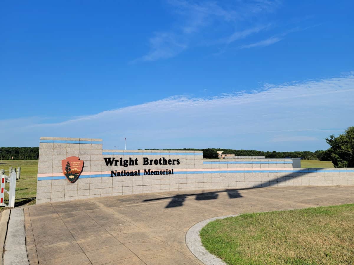 Wright Brothers National memorial entrance sign with the National Park Service Emblem
