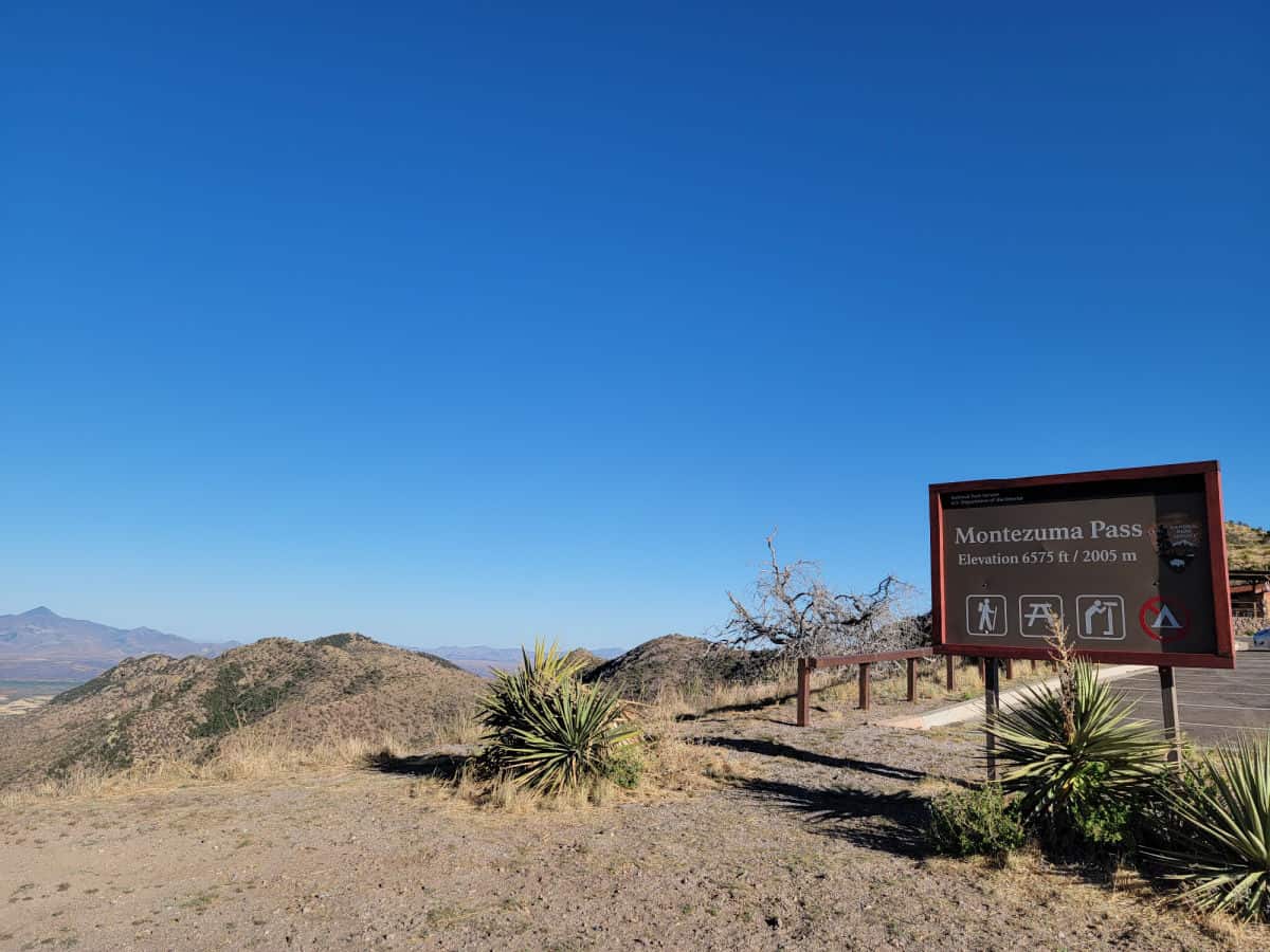 Montezuma Pass sign with views of the mountains in Coronado