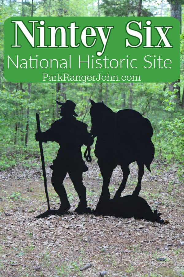 Ninety Six National Historic Site wriiten over a black outline statue of a soldier and a horse in the woods