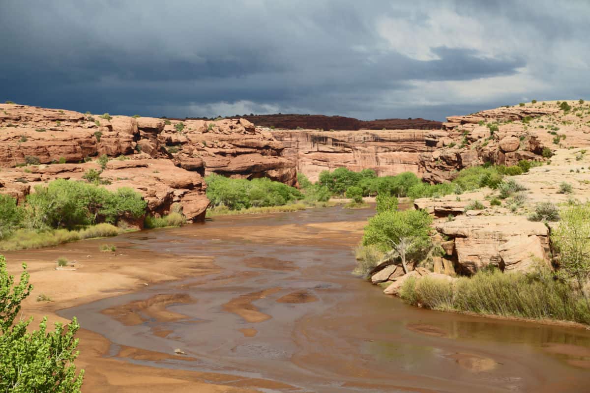 River running through Canyon de Chelly National Monument with cliffs on either side