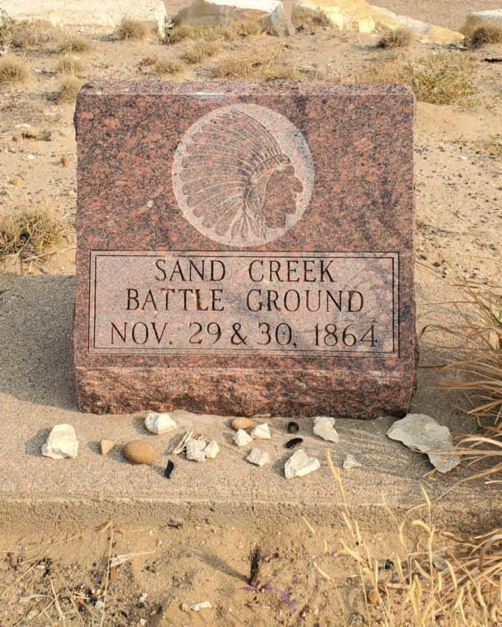 Sand Creek Battleground memorial stone with rocks around it